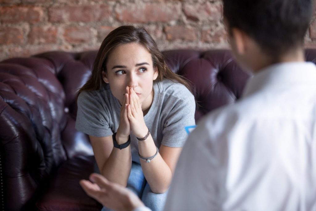 woman at therapy looking concerned